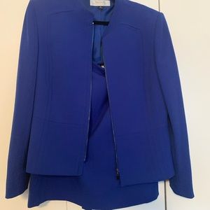 2 piece royal blue business suit with a zipper front.